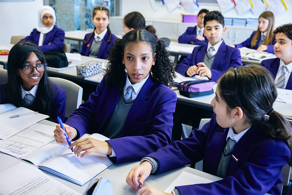 Secondary pupils working together discussing a group task