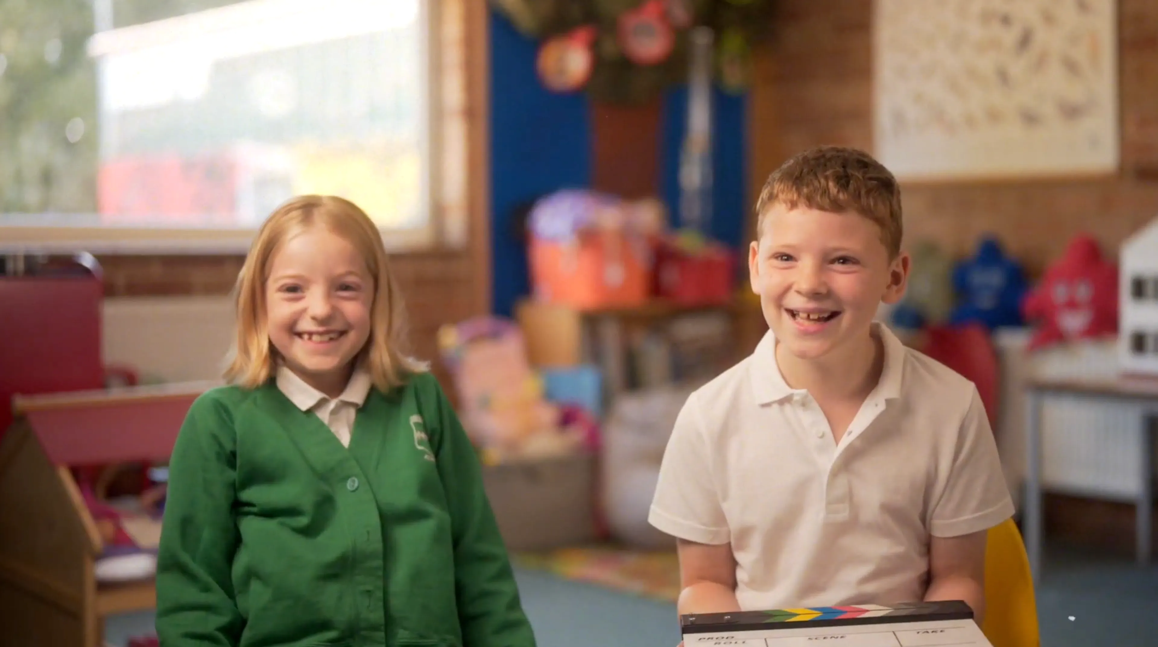 Two pupils laughing in a classroom